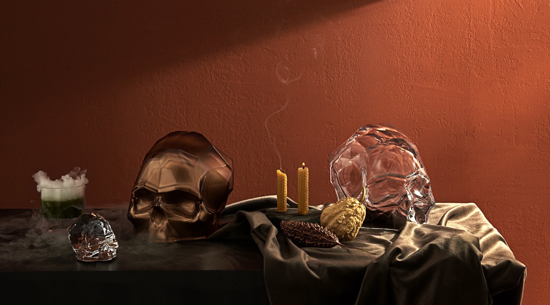 The NUDE Memento Mori Skull collection presented in a gloomy setting. The large skull is in clear and copper, and in the front the small skull with copper bottom is shown.