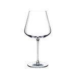 A clear NUDE Sera Red wine glass with a wide, gently flared bowl, a long slender stem, and a flat circular base, photographed on a plain white background.