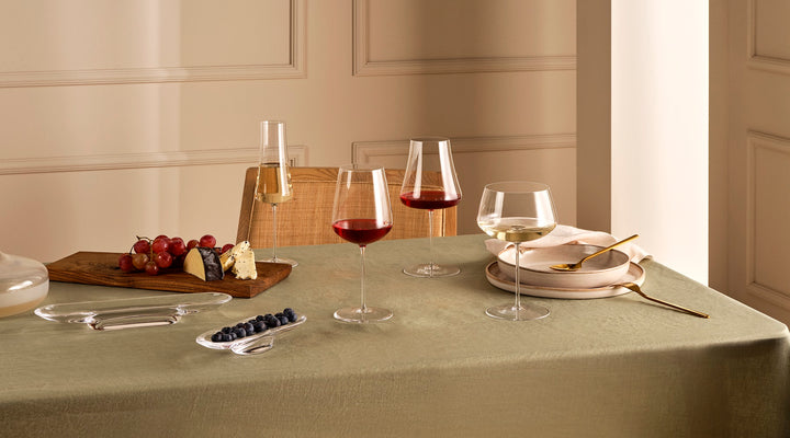 NUDE glass Stem Zero line - group of full bodied white wine glass, Volcano red wine glass, volcano champagne glass and powerful red wine glass presented on a table
