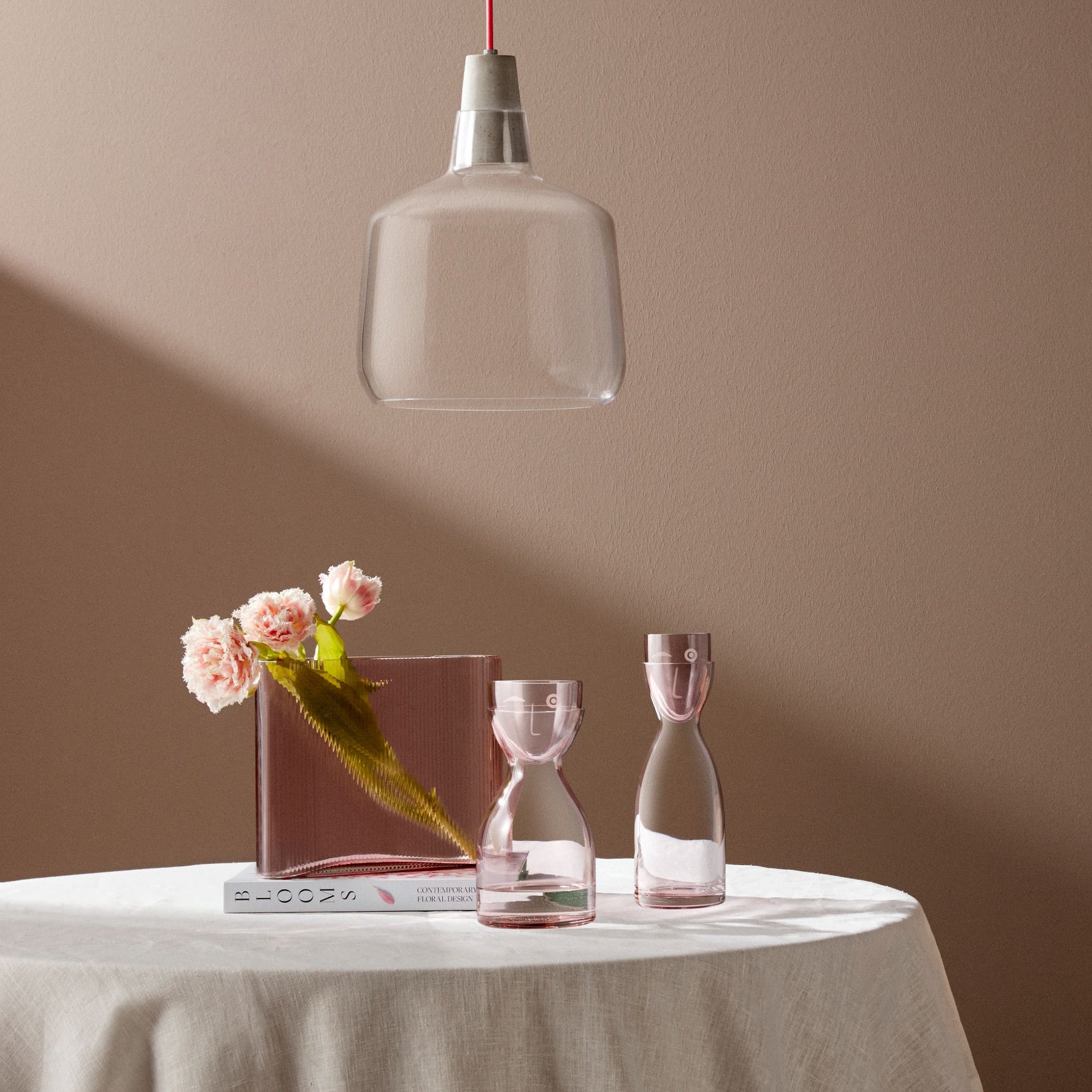 NUDE Mist Wide dusty rose vase with Mr Mrs short and tall water carafes in dusty rose and Mono pendant light styled on white linen table