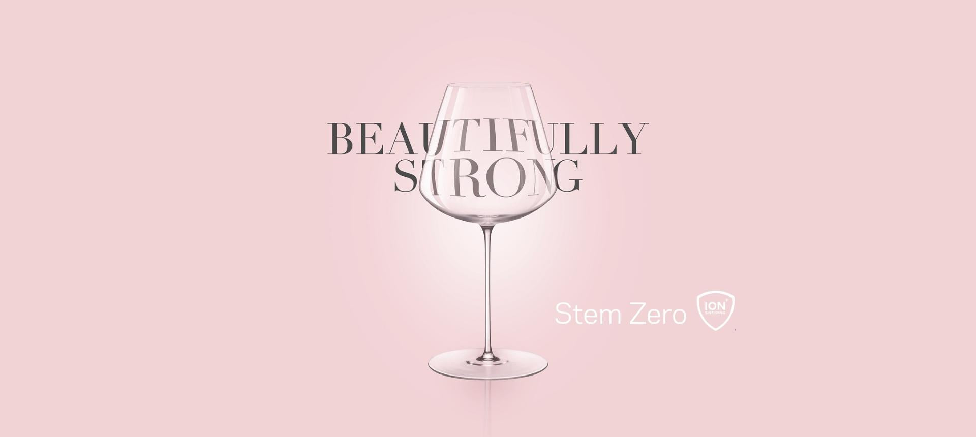 NUDE Stem Zero wine glass on a soft pink background with the words Beautifully Strong and the Ion Shielding Technology logo