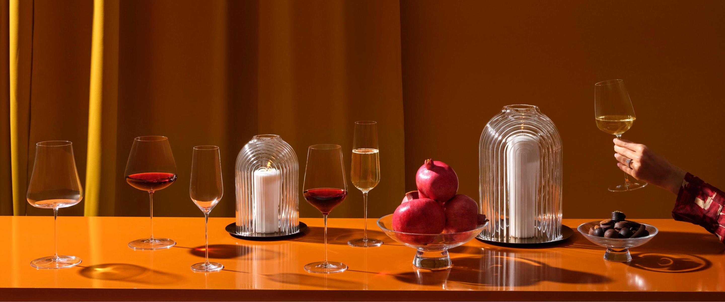 NUDE Stem Zero wine glasses, ILO candle holder and Silhouette bowls styled on a warm amber table setting