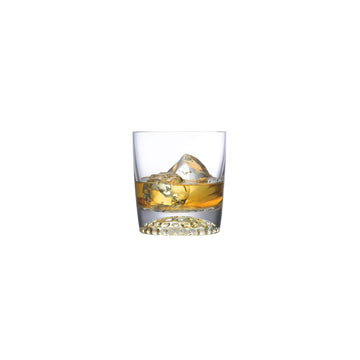 NUDE Ace whisky glass with golf pattern on the bottom filled with whisky